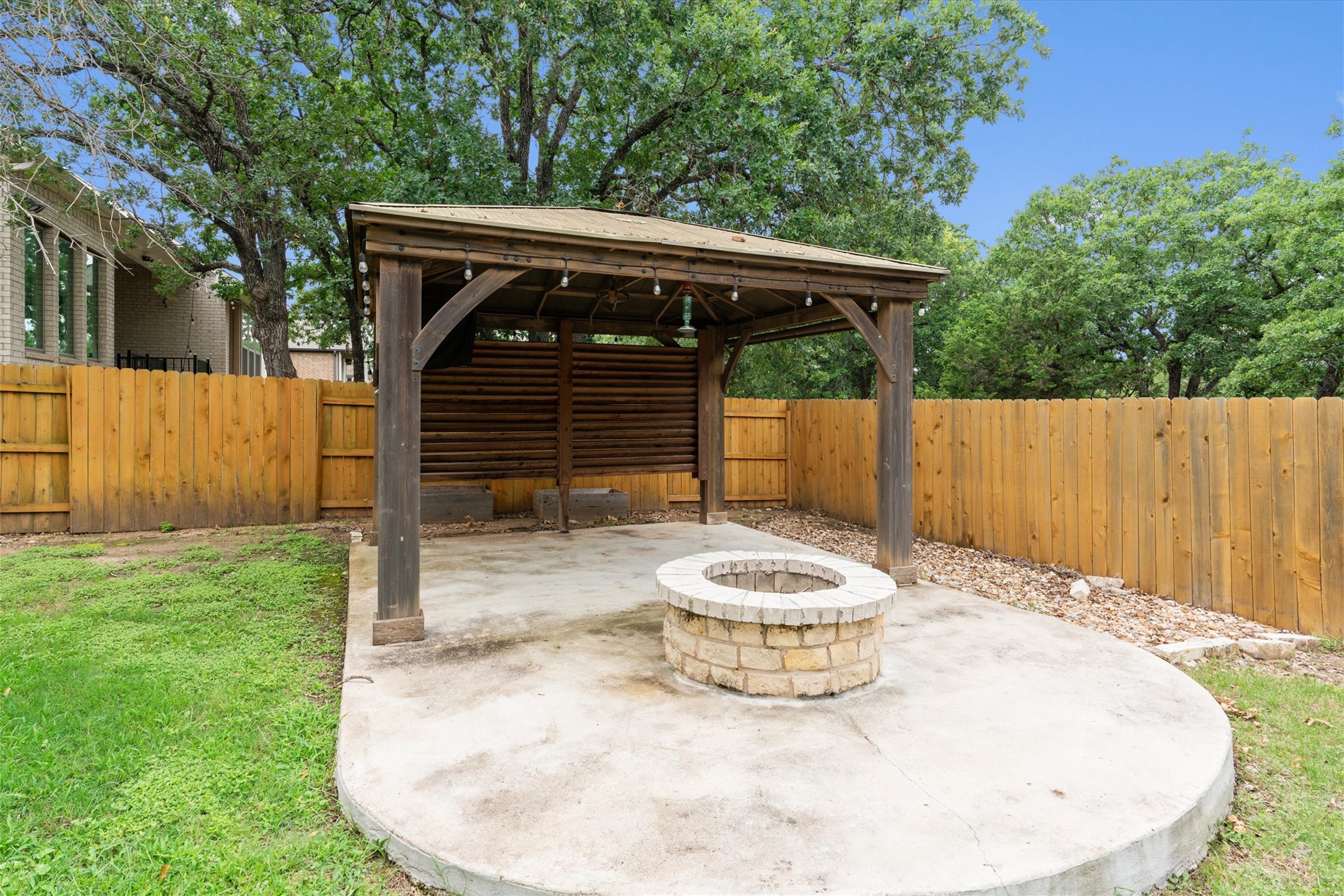 941 Del Raphael Drive Leander, TX 78641 - Photo 24 of 31 The built-in stone fire pit is the ultimate backyard destination for catching up with friends after the sun goes down