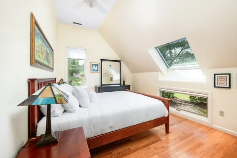 a bedroom with a bed and a potted plant