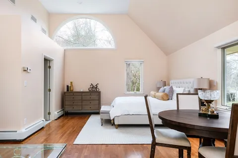 a bedroom with furniture and a window