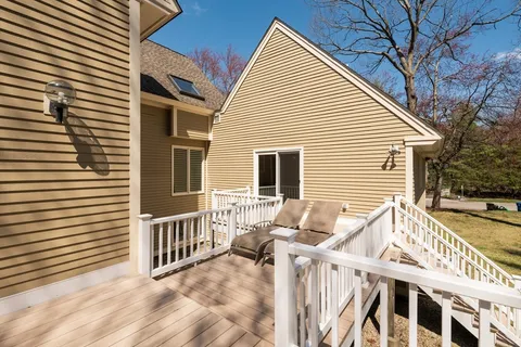 a view of a house with a small deck and a wooden floor