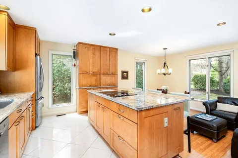 a kitchen that has a sink a stove and a table in it