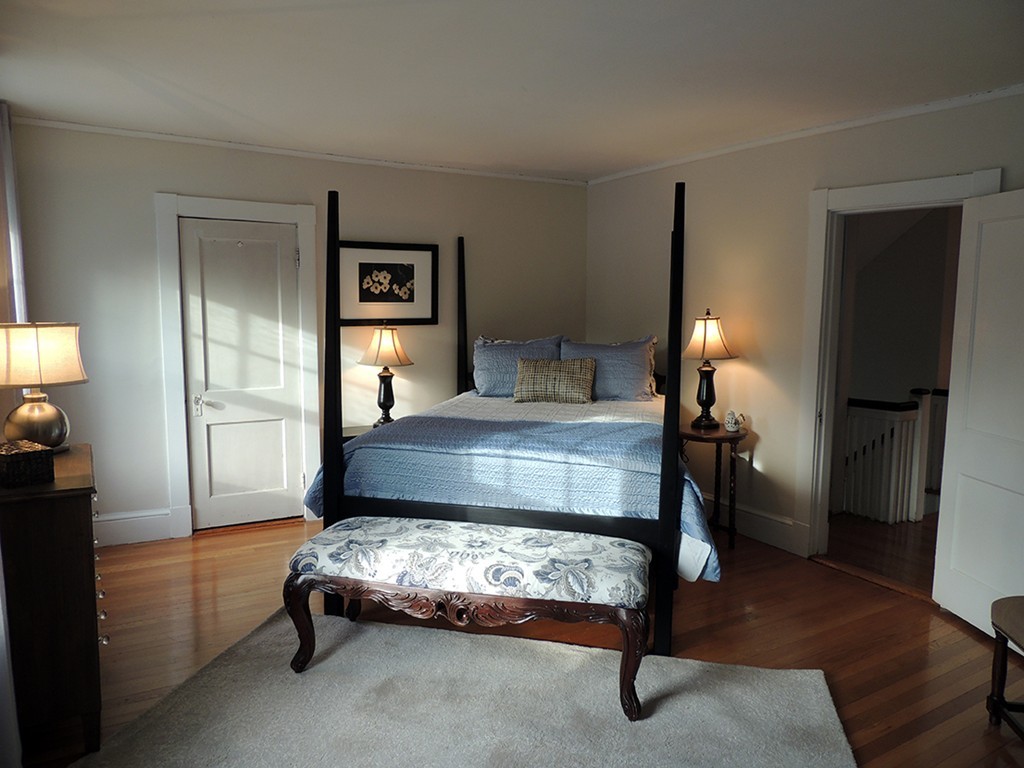 22 Symmes Road Winchester, MA 01890 - Photo 6 of 20 a bedroom with a bed and a lamp on table