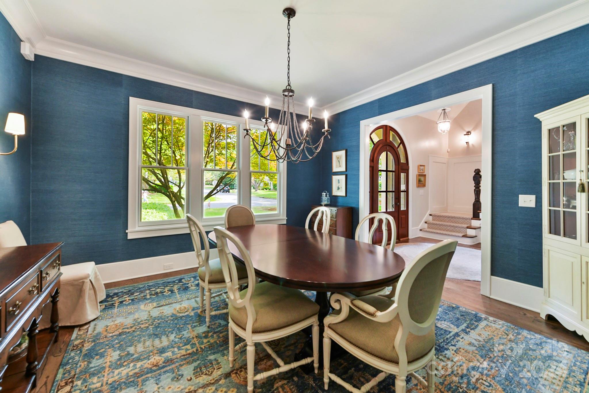 3201 Wickersham Road Charlotte, NC 28211 - Photo 12 of 43 a dining room with furniture a chandelier and wooden floor