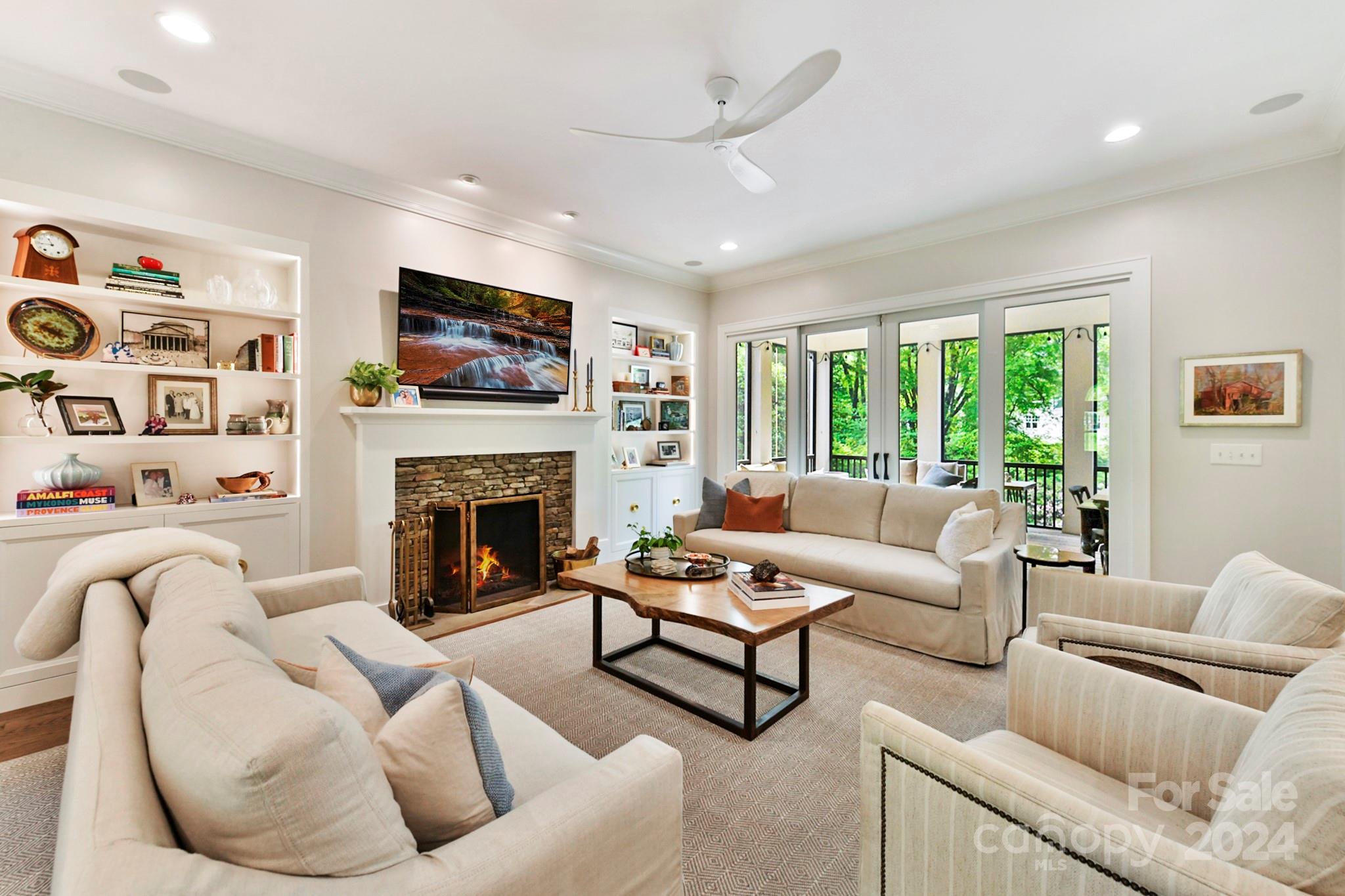 3201 Wickersham Road Charlotte, NC 28211 - Photo 15 of 43 a living room with furniture a fireplace and a flat screen tv