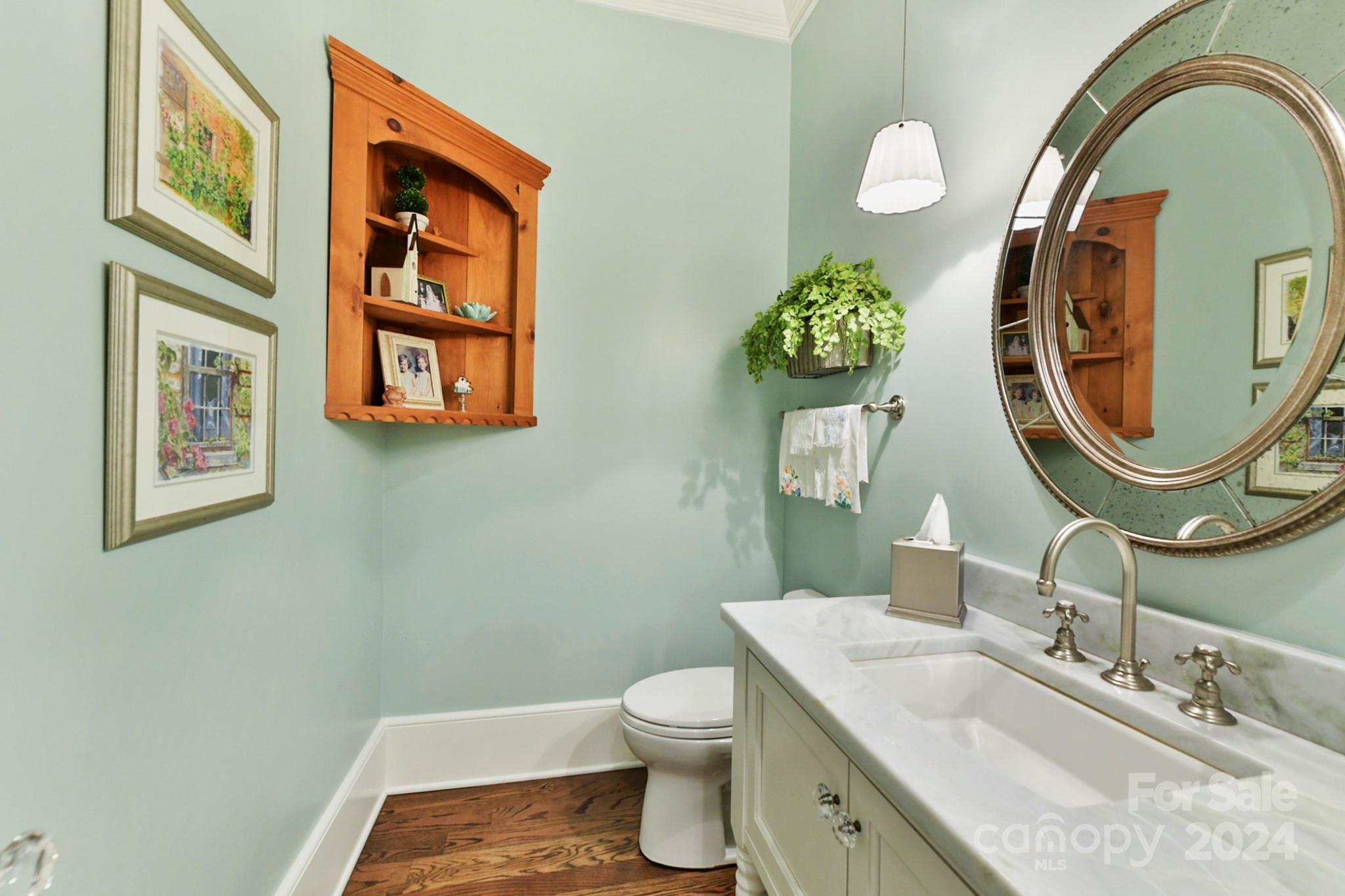 3201 Wickersham Road Charlotte, NC 28211 - Photo 19 of 43 a bathroom with a granite countertop toilet a sink and a mirror