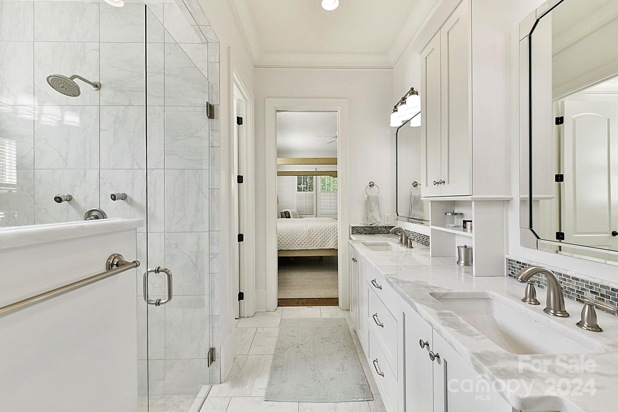 3201 Wickersham Road Charlotte, NC 28211 - Photo 22 of 43 a bathroom with a double vanity sink a mirror a bathtub and shower