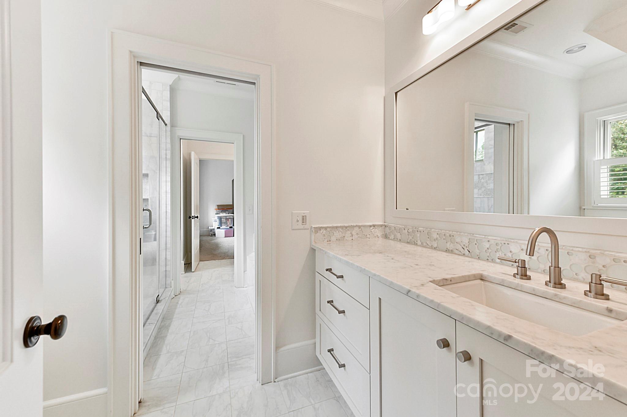 3201 Wickersham Road Charlotte, NC 28211 - Photo 24 of 43 a en suite bathroom with a sink and mirror