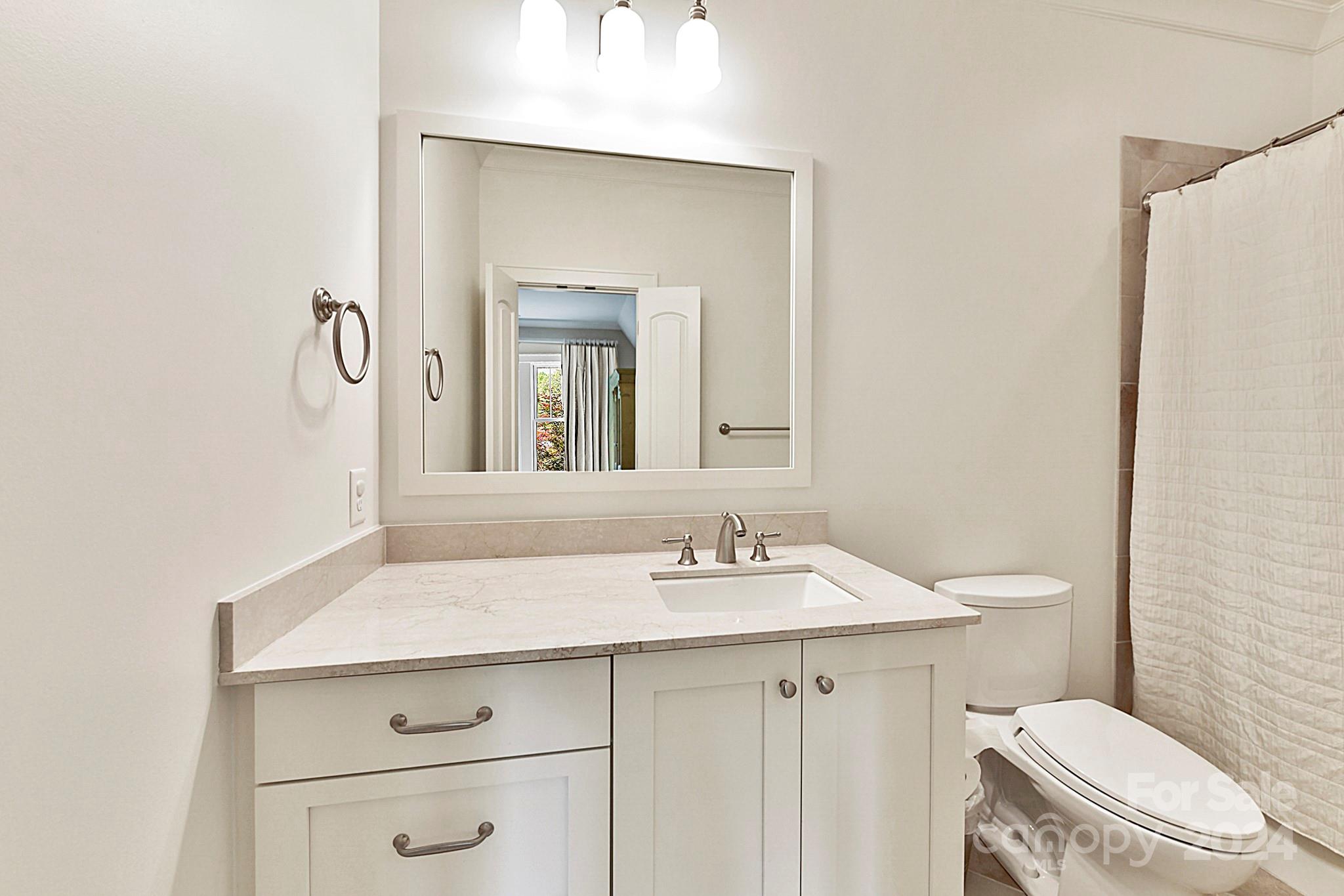 3201 Wickersham Road Charlotte, NC 28211 - Photo 28 of 43 a bathroom with a sink toilet and mirror