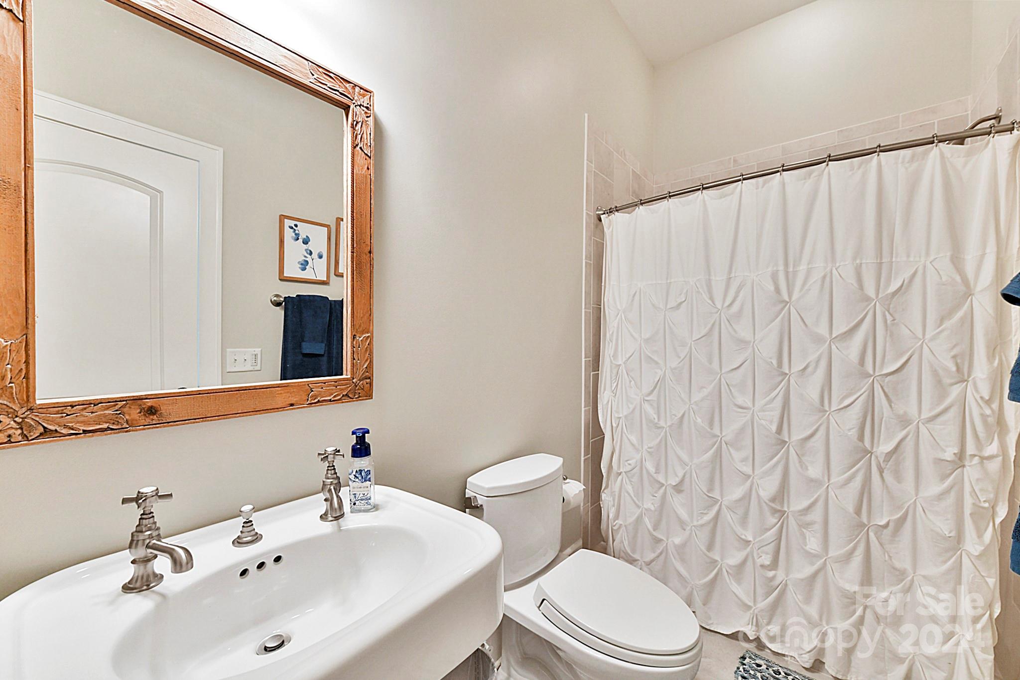 3201 Wickersham Road Charlotte, NC 28211 - Photo 32 of 43 a bathroom with a sink and a mirror