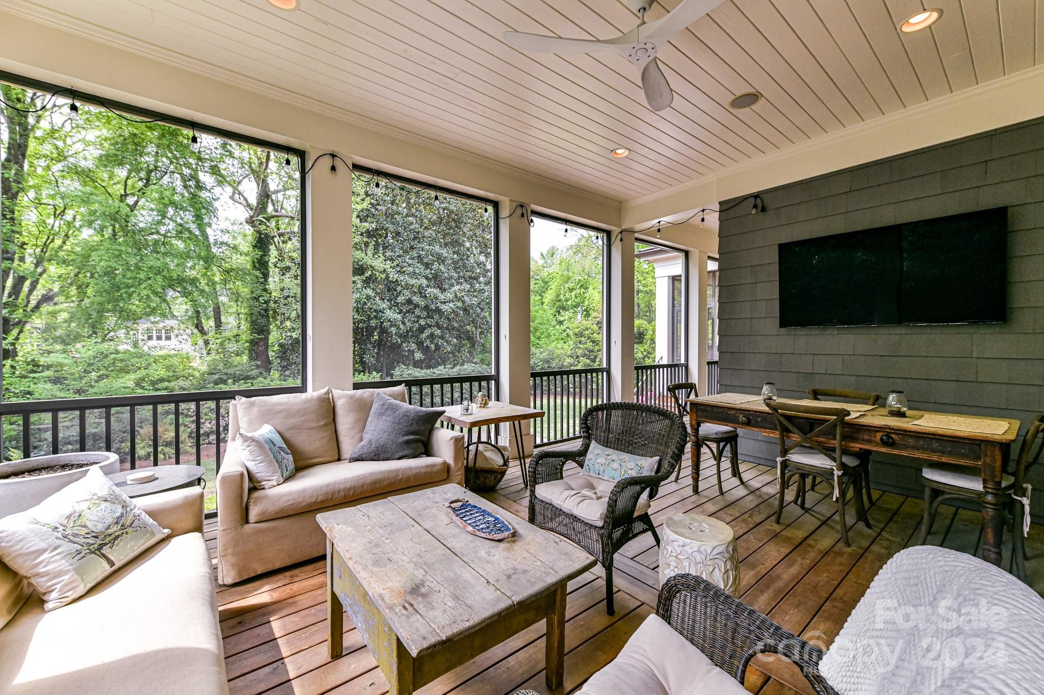 3201 Wickersham Road Charlotte, NC 28211 - Photo 33 of 43 a living room with furniture a flat screen tv and a floor to ceiling window