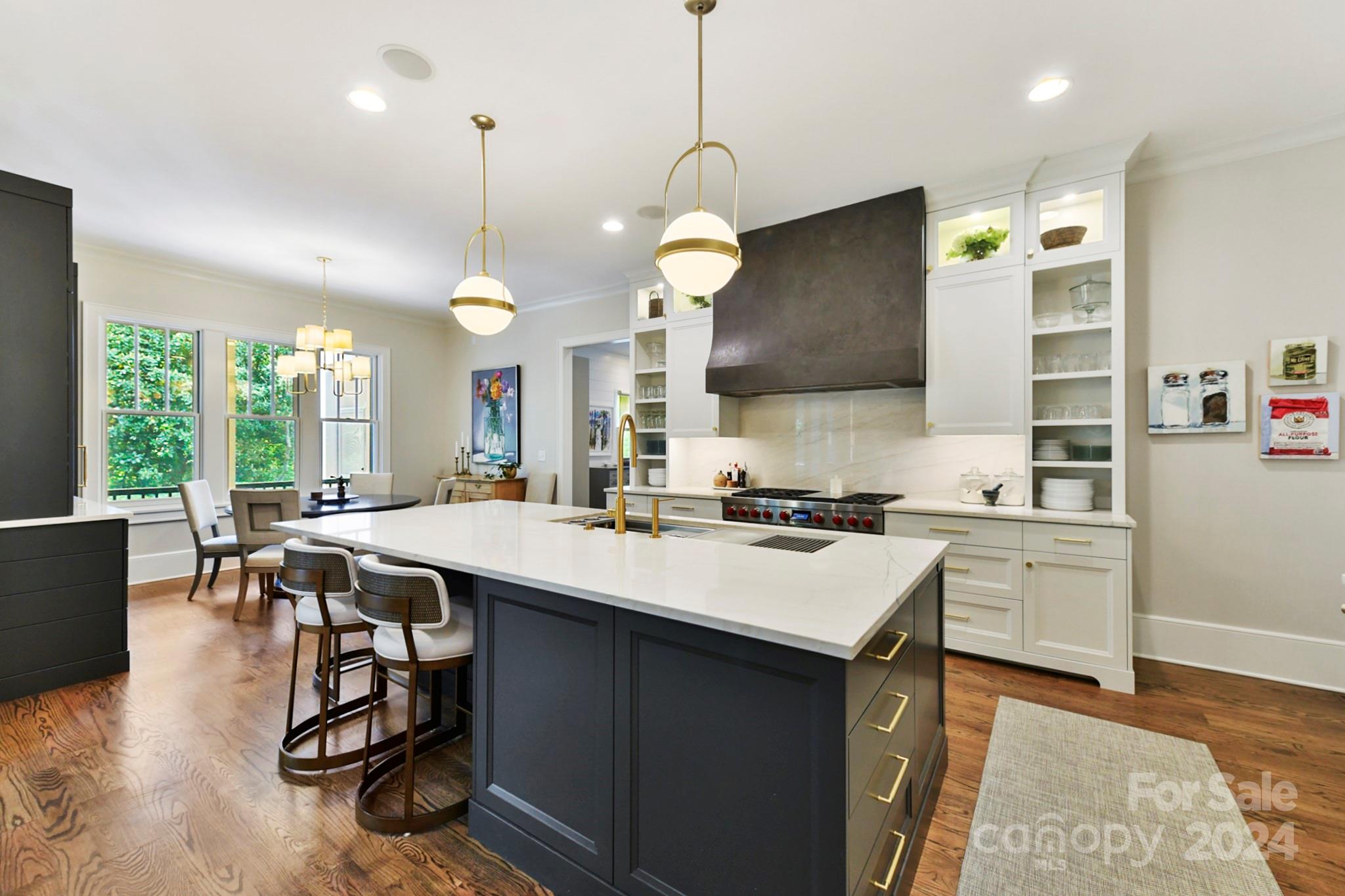 3201 Wickersham Road Charlotte, NC 28211 - Photo 5 of 43 a kitchen with a sink a stove and chairs with wooden floor