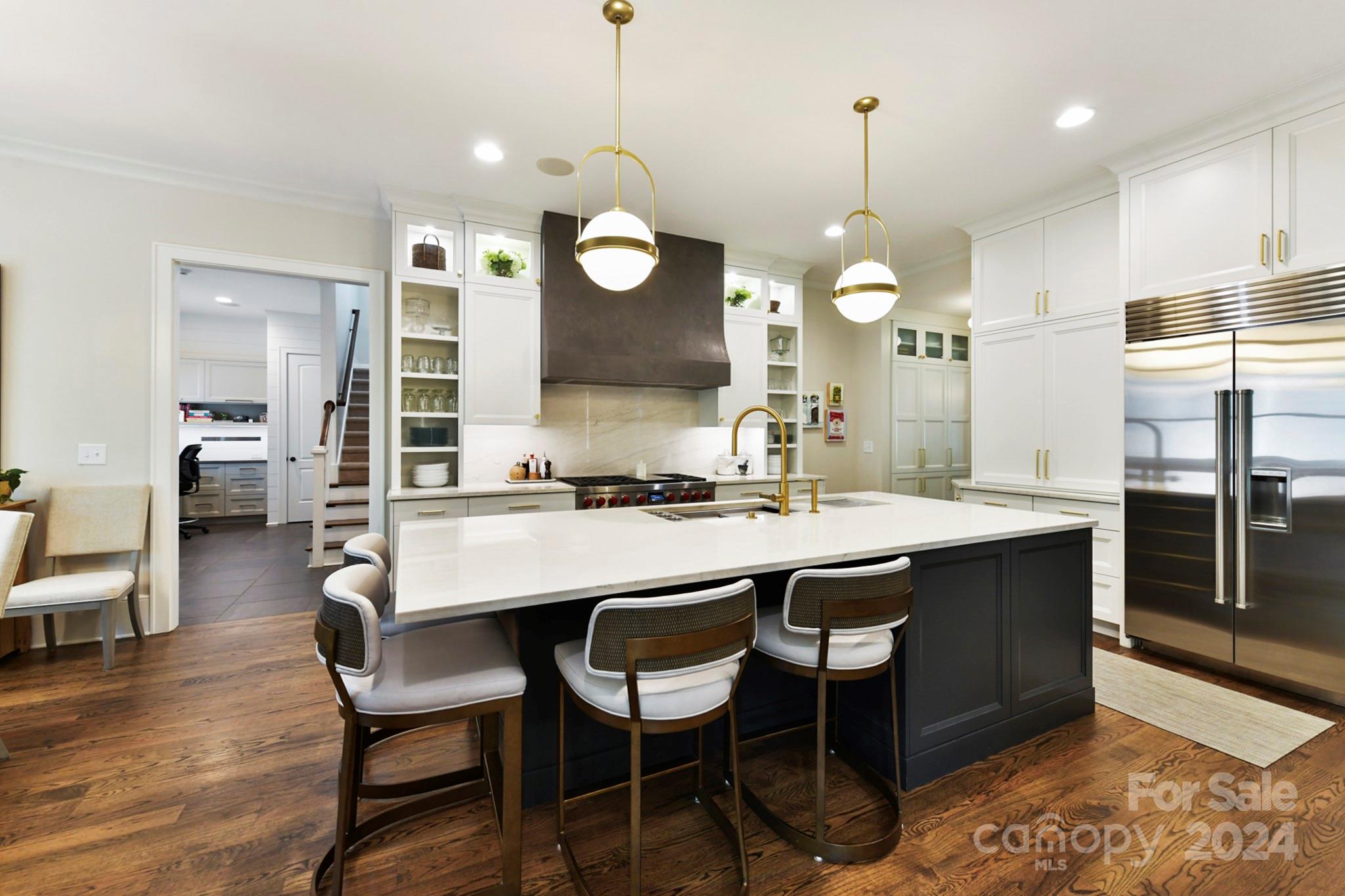 3201 Wickersham Road Charlotte, NC 28211 - Photo 6 of 43 a kitchen with a dining table chairs sink and wooden floor