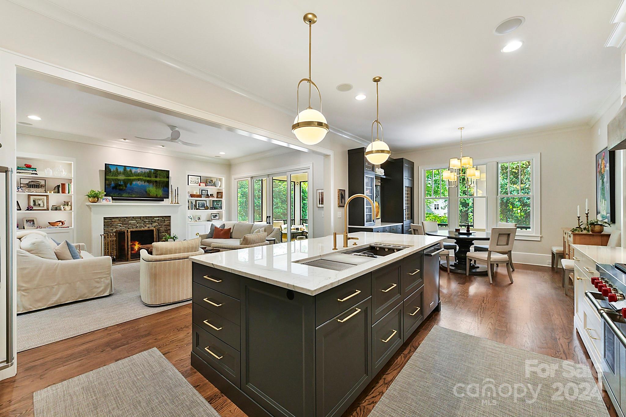 3201 Wickersham Road Charlotte, NC 28211 - Photo 7 of 43 a kitchen with a stove a sink dishwasher and a fireplace with wooden floor