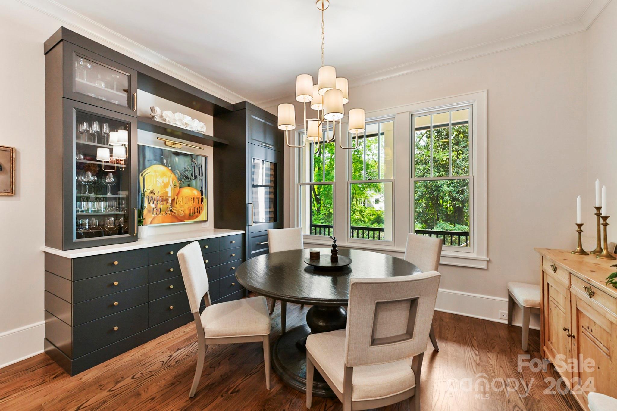 3201 Wickersham Road Charlotte, NC 28211 - Photo 10 of 43 a dining room with furniture a chandelier and wooden floor