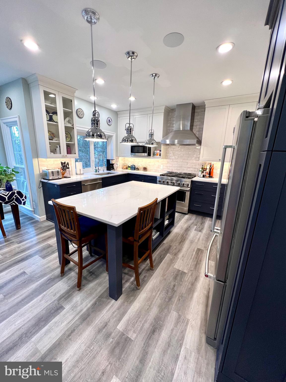 9706 Hidden Valley Road Vienna, VA 22181 - Photo 14 of 43 a large kitchen with a table and chairs