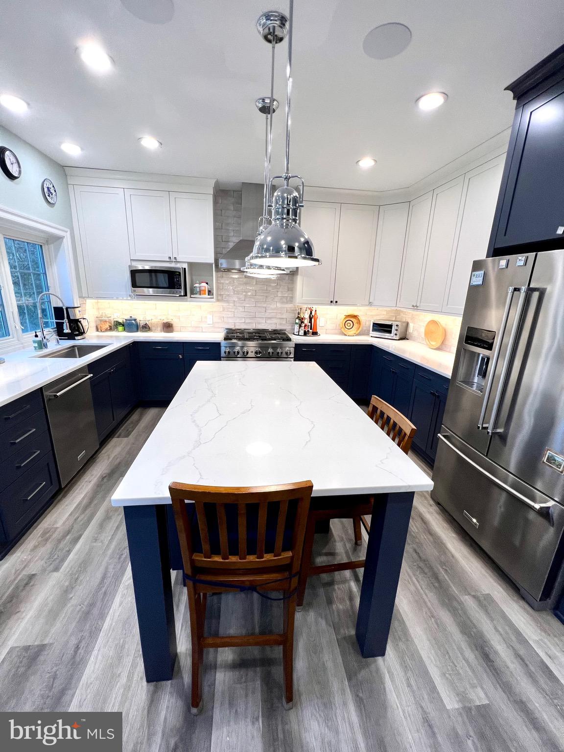 9706 Hidden Valley Road Vienna, VA 22181 - Photo 15 of 43 a large kitchen with lots of counter space a sink and appliances