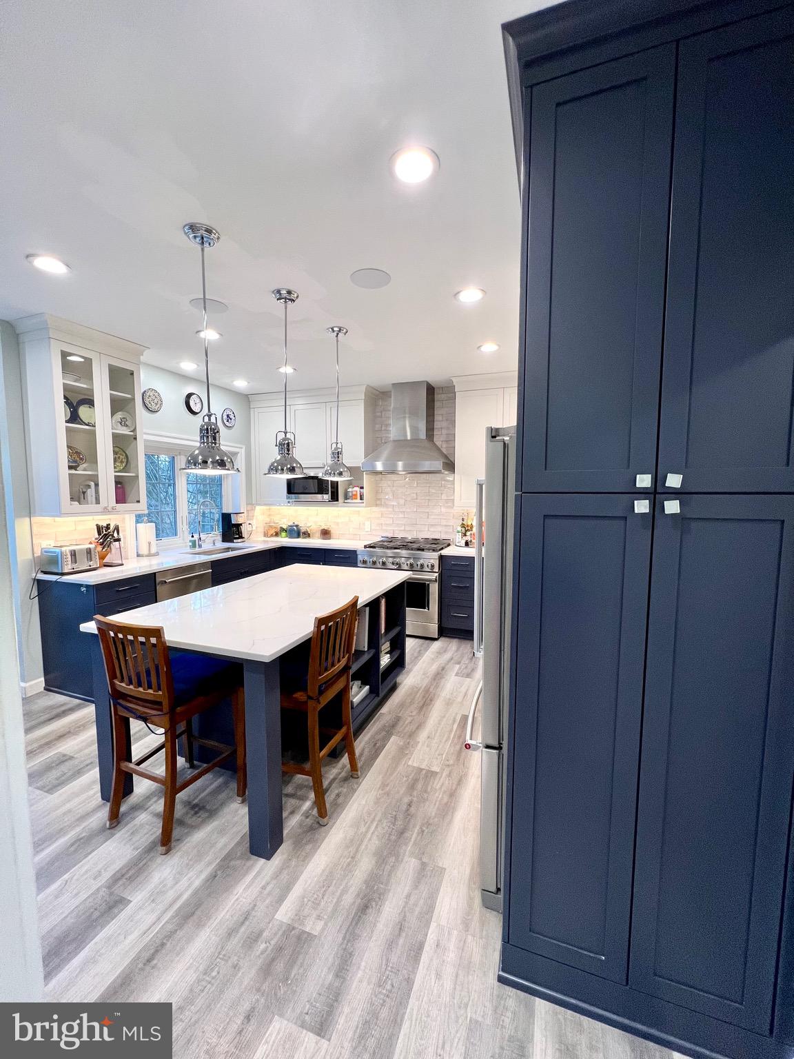 9706 Hidden Valley Road Vienna, VA 22181 - Photo 16 of 43 a large kitchen with a table and chairs in it