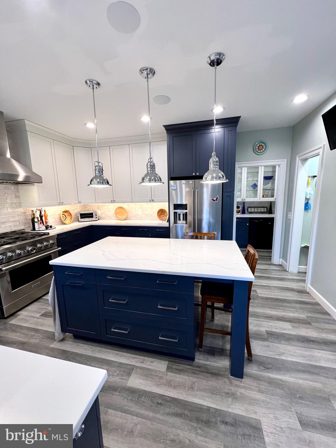 9706 Hidden Valley Road Vienna, VA 22181 - Photo 17 of 43 a kitchen with a stove a refrigerator and a wooden floor