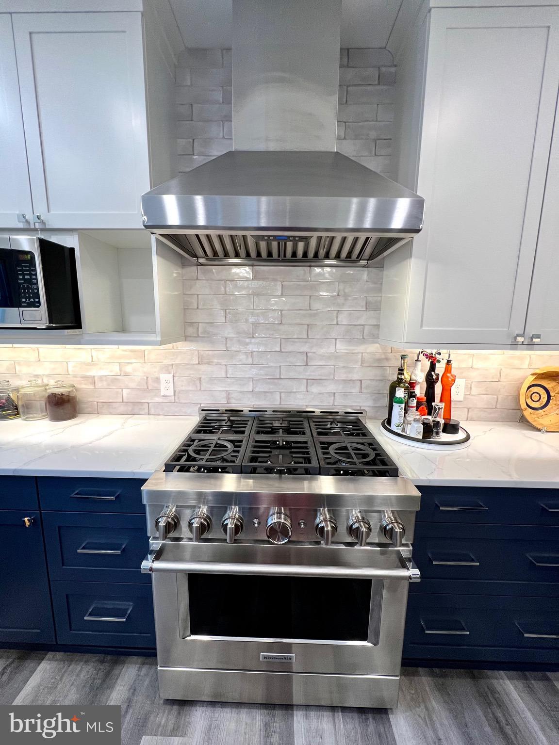 9706 Hidden Valley Road Vienna, VA 22181 - Photo 18 of 43 a stove top oven sitting inside of a kitchen
