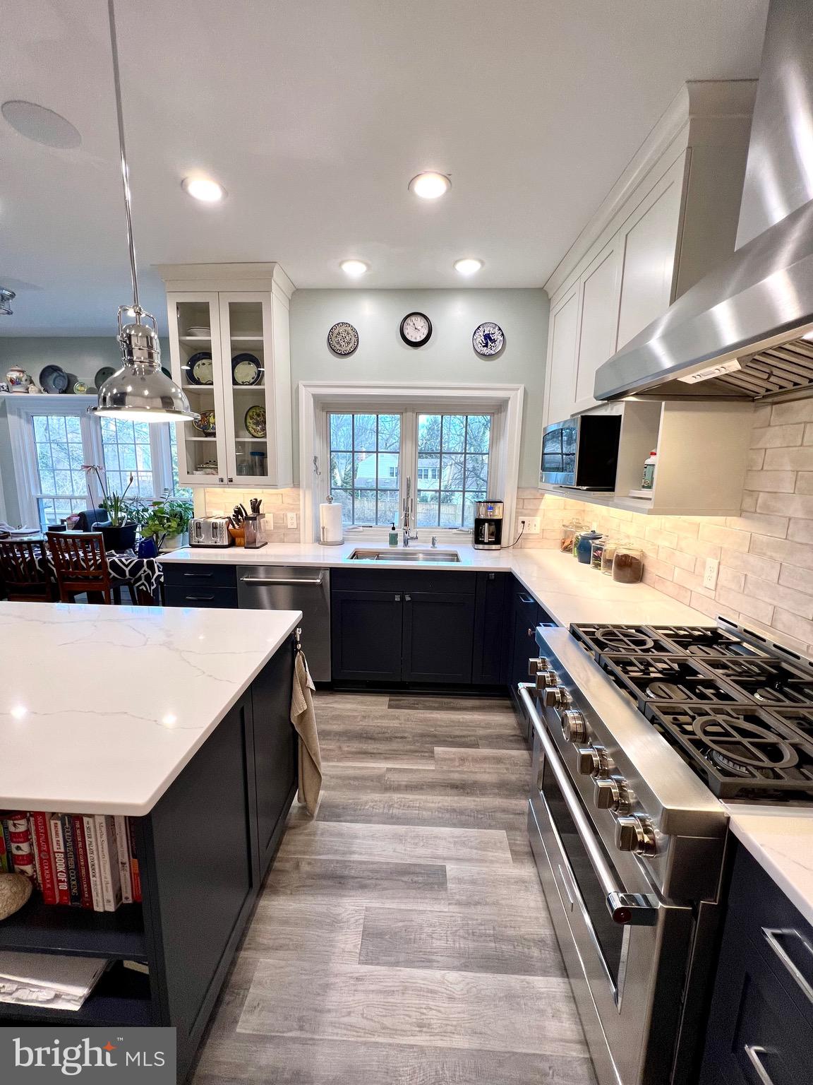 9706 Hidden Valley Road Vienna, VA 22181 - Photo 19 of 43 a large kitchen with stainless steel appliances granite countertop a stove and a sink