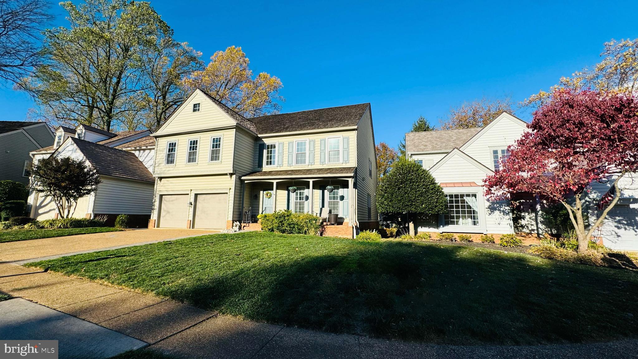 9706 Hidden Valley Road Vienna, VA 22181 - Photo 2 of 43 a front view of a house with a yard