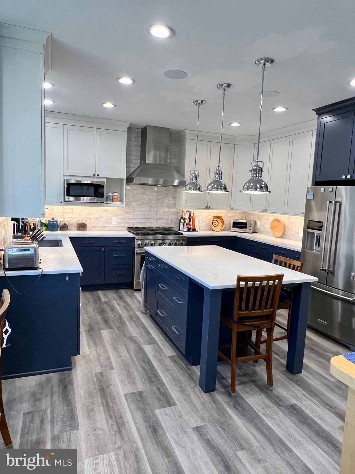 9706 Hidden Valley Road Vienna, VA 22181 - Photo 21 of 43 a large kitchen with wooden cabinets and stainless steel appliances