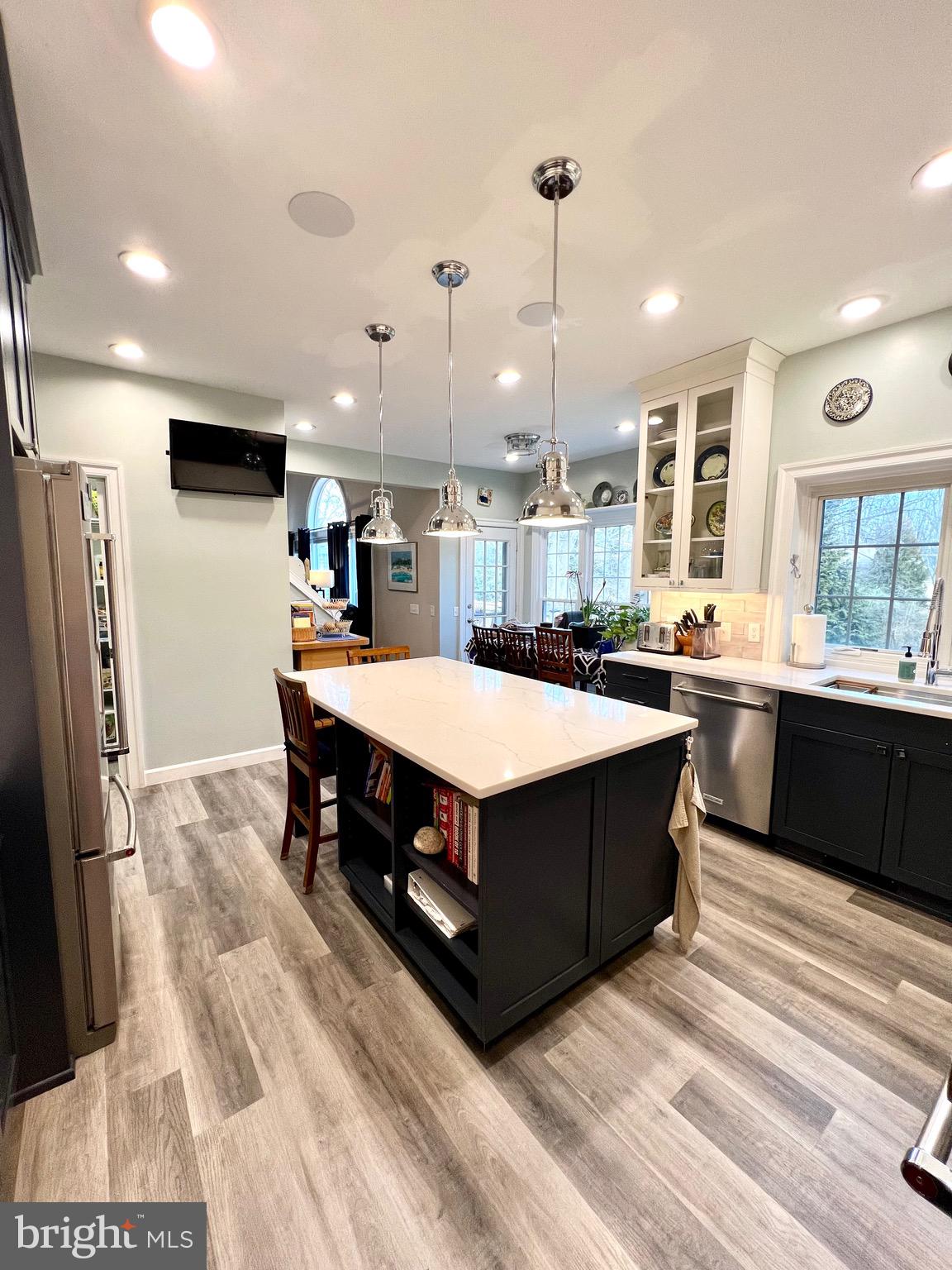 9706 Hidden Valley Road Vienna, VA 22181 - Photo 22 of 43 a kitchen with stainless steel appliances kitchen island a sink and a refrigerator