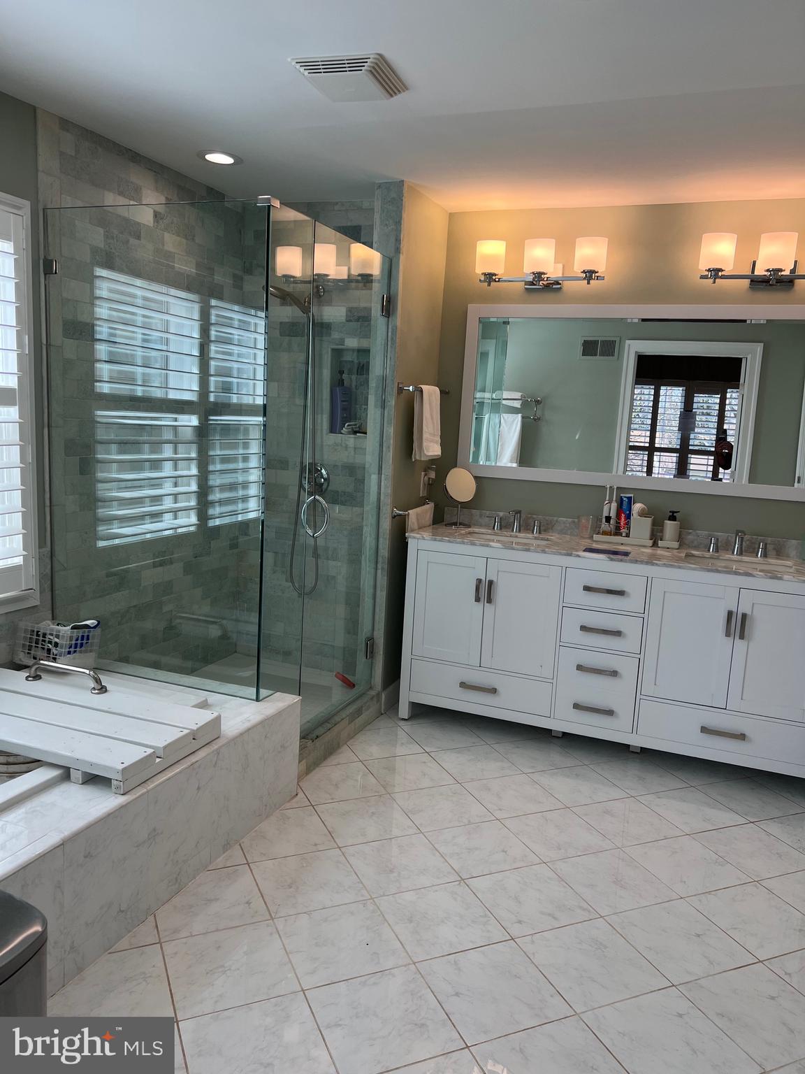9706 Hidden Valley Road Vienna, VA 22181 - Photo 27 of 43 a bath room with a sink and mirror