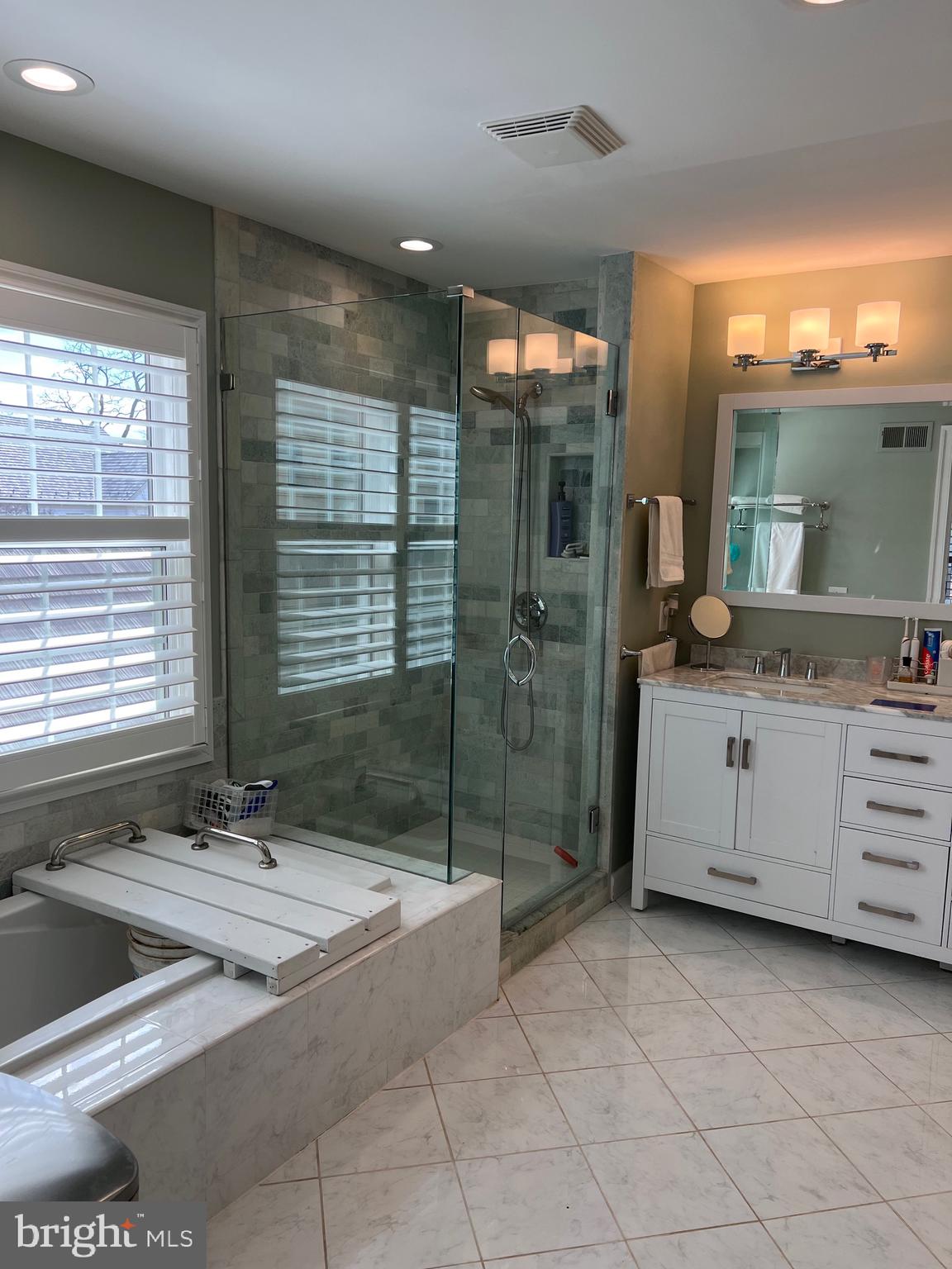 9706 Hidden Valley Road Vienna, VA 22181 - Photo 29 of 43 a bathroom with a granite countertop sink and a mirror