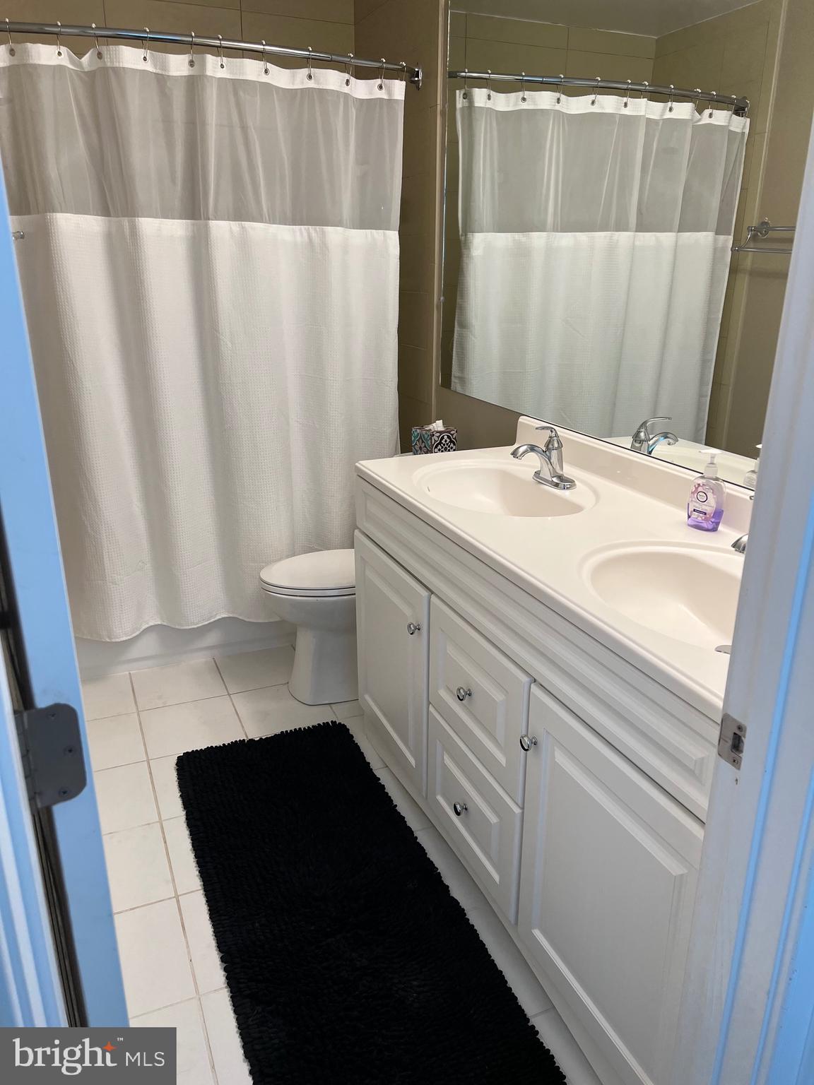 9706 Hidden Valley Road Vienna, VA 22181 - Photo 31 of 43 a bathroom with a sink and a mirror