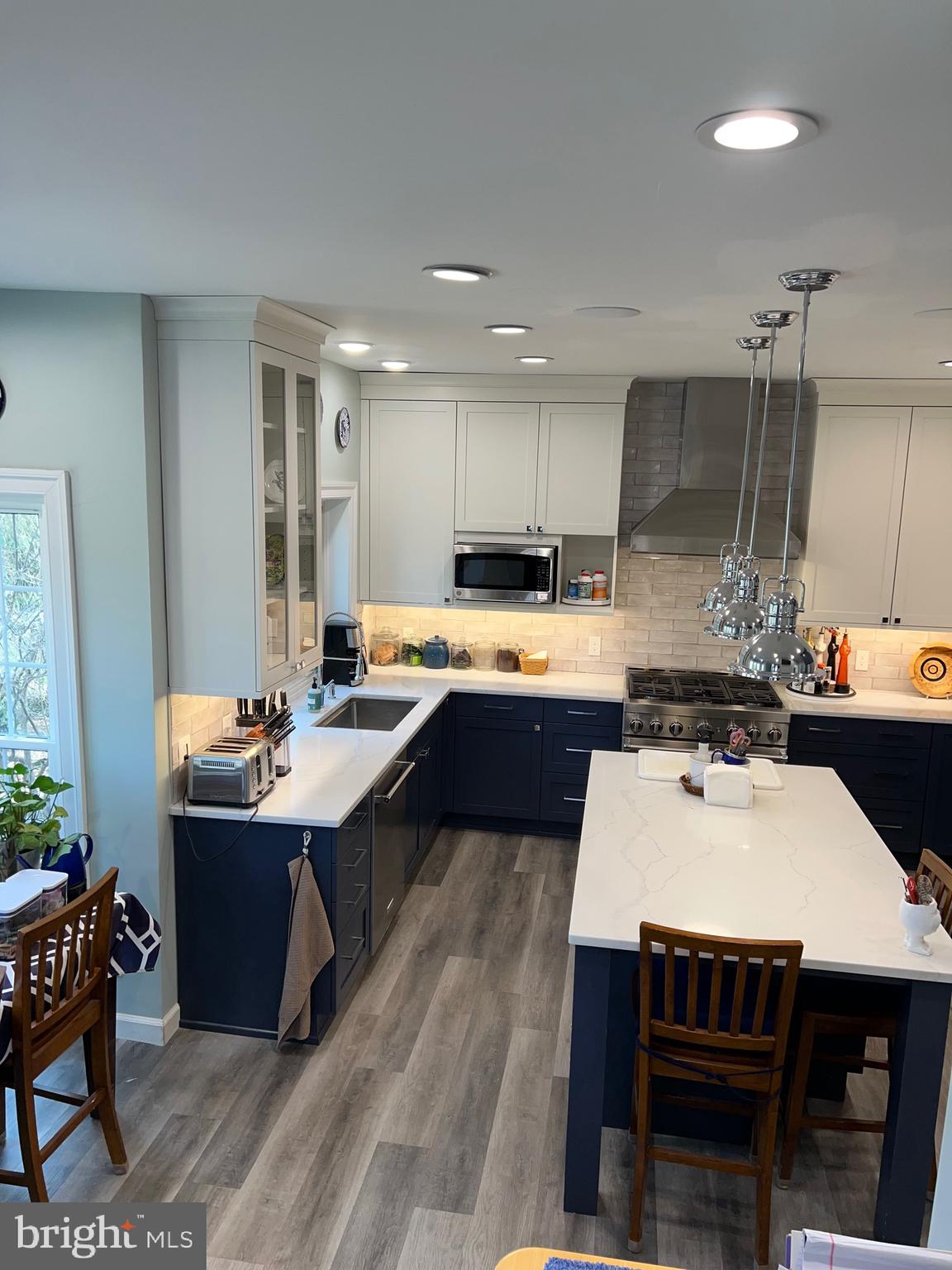 9706 Hidden Valley Road Vienna, VA 22181 - Photo 37 of 43 a kitchen with a table chairs sink and cabinets