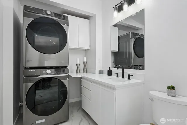 a utility room with sink dryer and washer