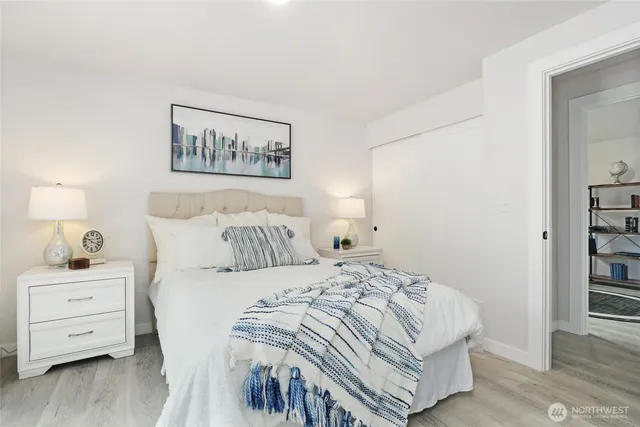 a bedroom with a bed and a tv on the dresser