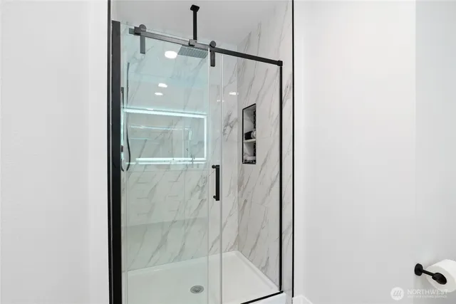 a bathroom with a glass shower door