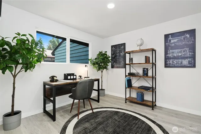 a living room with furniture a potted plant and a table