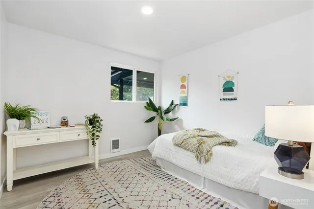 a bedroom with a bed and a couch