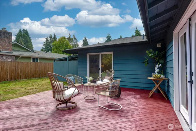 a view of a house with backyard and sitting area