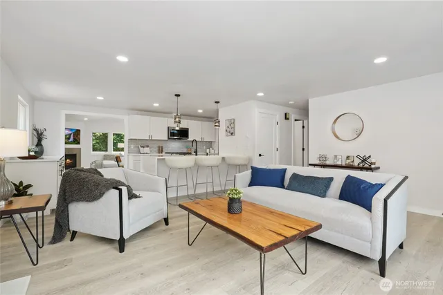 a living room with furniture and kitchen view