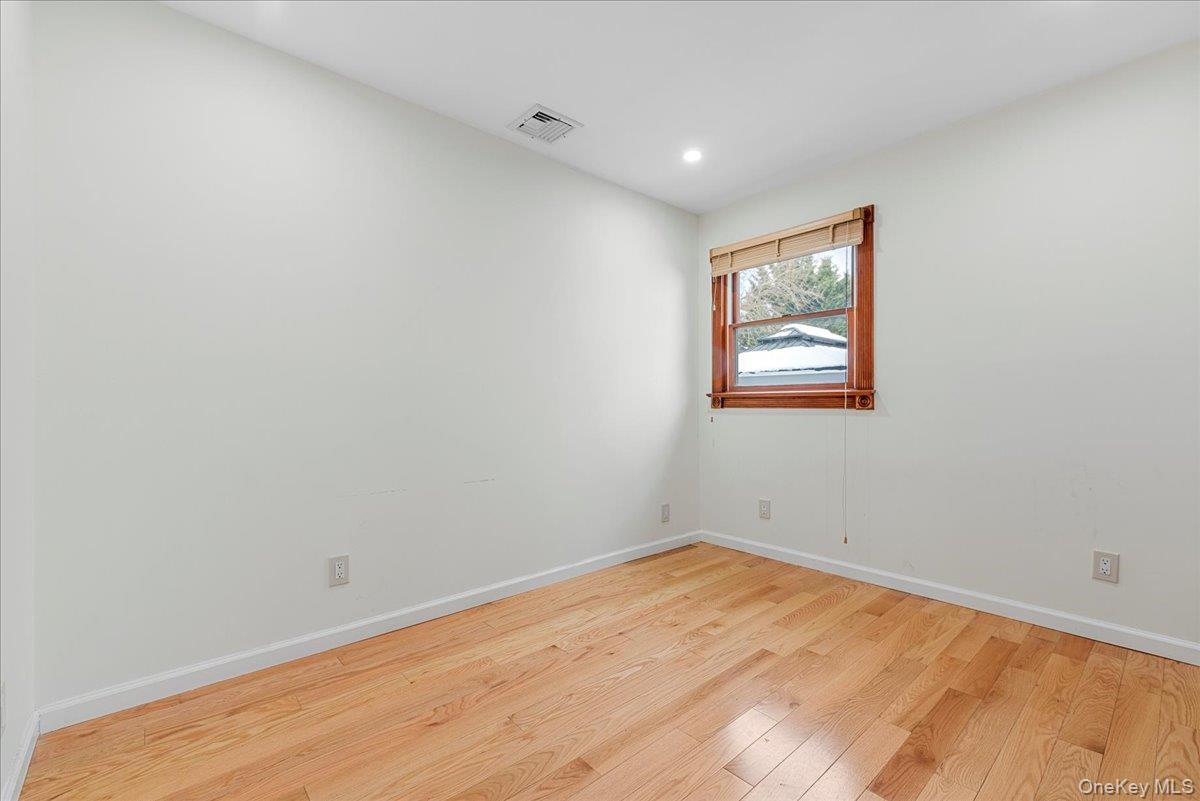 85 Briarcliff Road Westbury, NY 11590 - Photo 20 of 31 Unfurnished room featuring hardwood / wood-style flooring and recessed lighting
