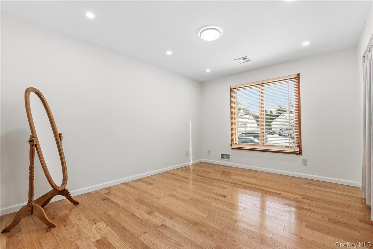 85 Briarcliff Road Westbury, NY 11590 - Photo 21 of 31 Empty room featuring light wood-style flooring and recessed lighting