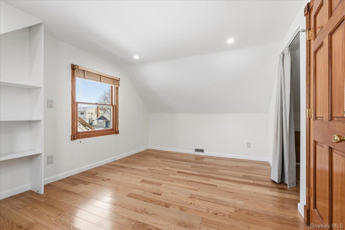 85 Briarcliff Road Westbury, NY 11590 - Photo 25 of 31 Bonus room with light wood finished floors, lofted ceiling, and recessed lighting