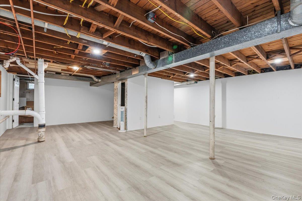 85 Briarcliff Road Westbury, NY 11590 - Photo 27 of 31 Finished below grade area with light wood finished floors