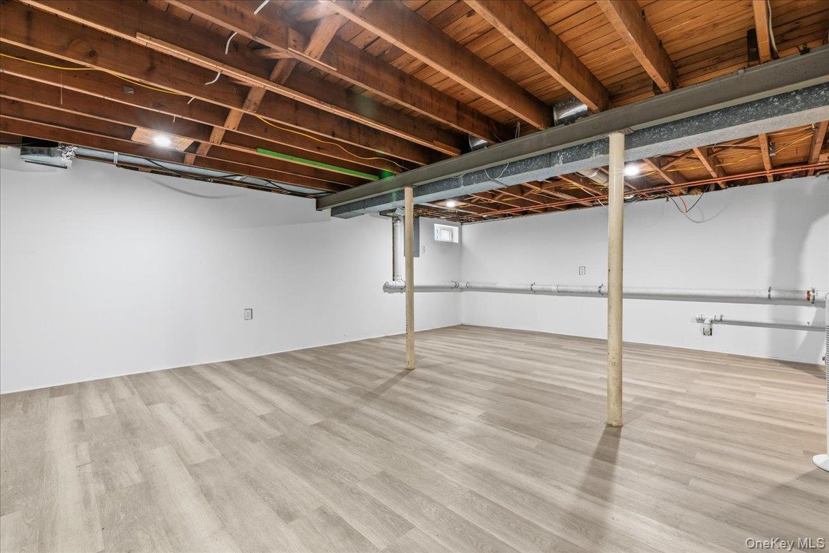 85 Briarcliff Road Westbury, NY 11590 - Photo 28 of 31 Finished basement featuring light wood finished floors