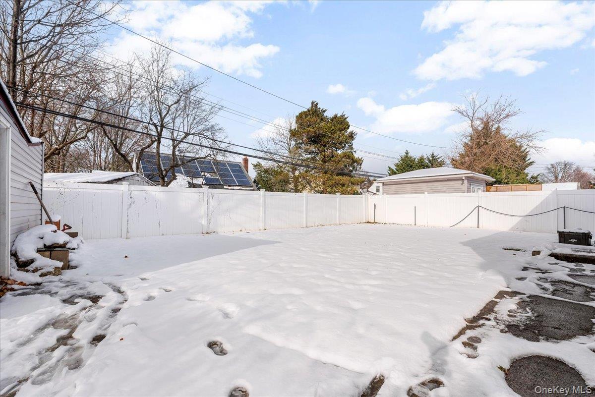 85 Briarcliff Road Westbury, NY 11590 - Photo 30 of 31 Snowy yard with a fenced backyard