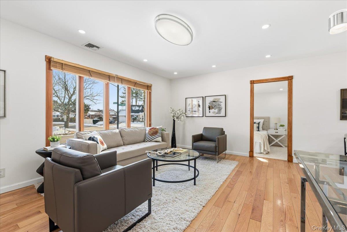 85 Briarcliff Road Westbury, NY 11590 - Photo 5 of 31 Living room featuring light wood finished floors and recessed lighting