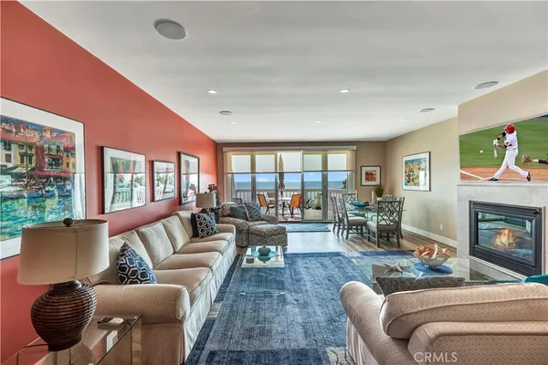 a living room with furniture fireplace and a large window