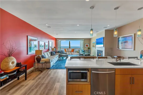 a open kitchen with stainless steel appliances granite countertop a stove and a sink