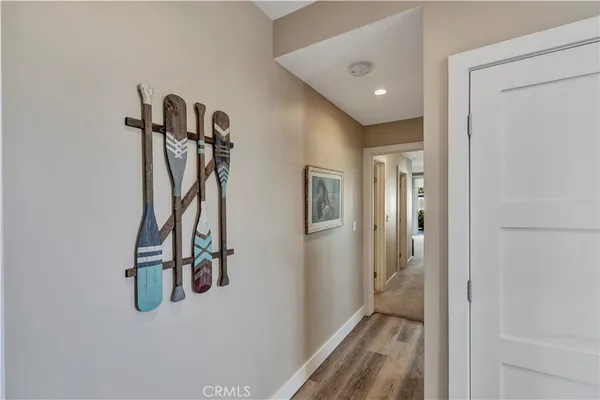 a view of a hallway with wooden floor and entryway