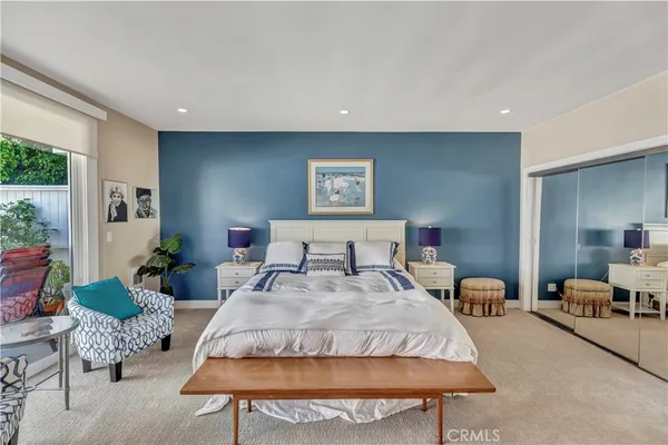 a bedroom with bed and a couch