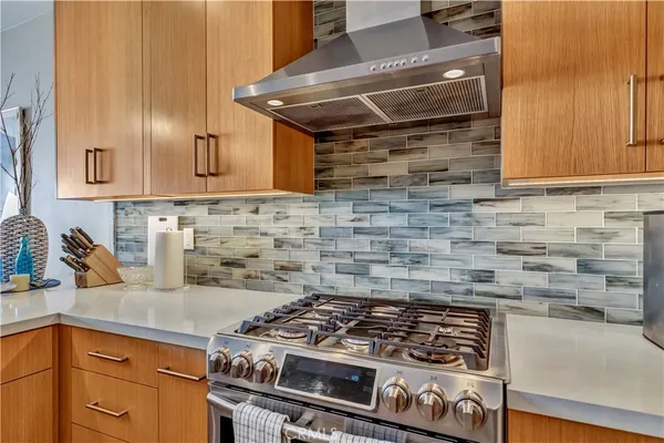 a kitchen with granite countertop cabinets and a stove top oven